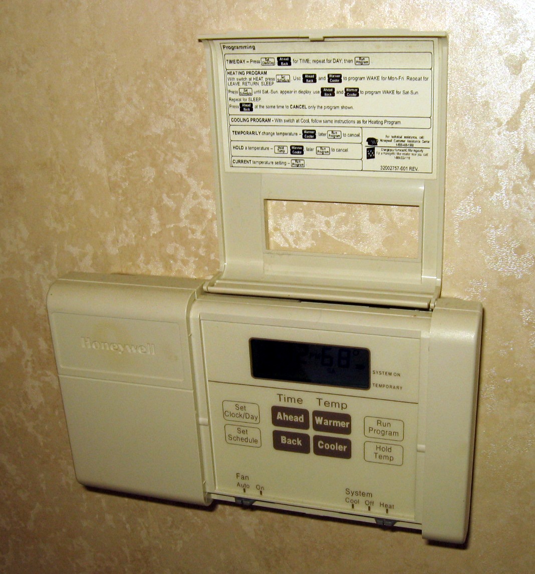 "Residential electronic thermostat on a wall"